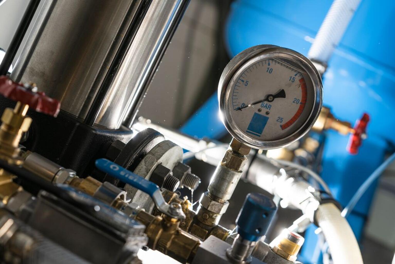 Hydrogen compressor against a blue background